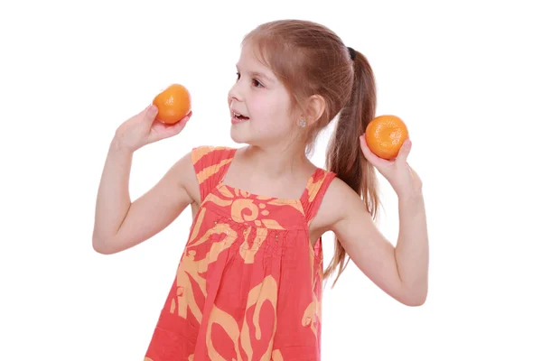 Girl holding mandarins — Stock Photo, Image