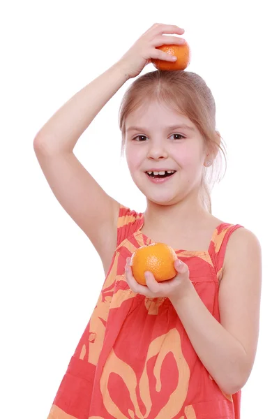 Girl holding mandarins — Stock Photo, Image