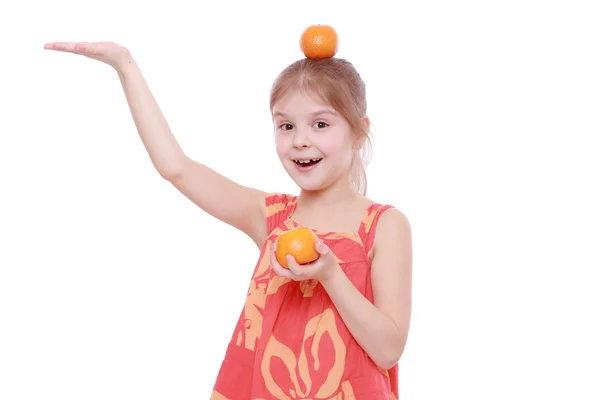 Girl holding mandarins — Stock Photo, Image