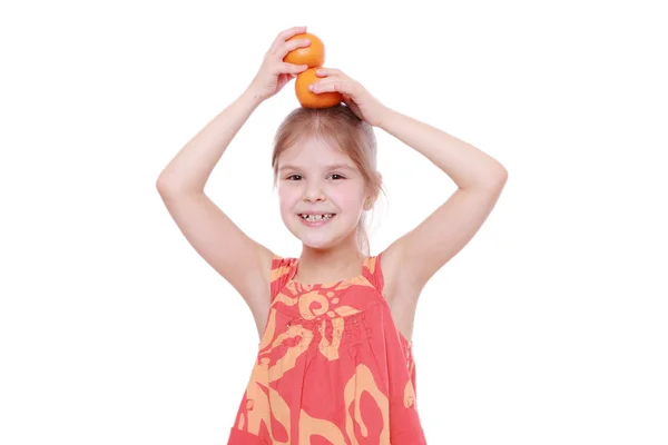 Girl holding mandarins — Stock Photo, Image