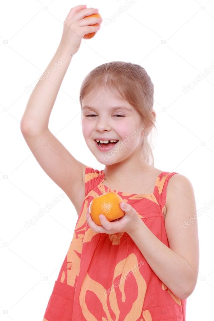 Girl holding mandarins