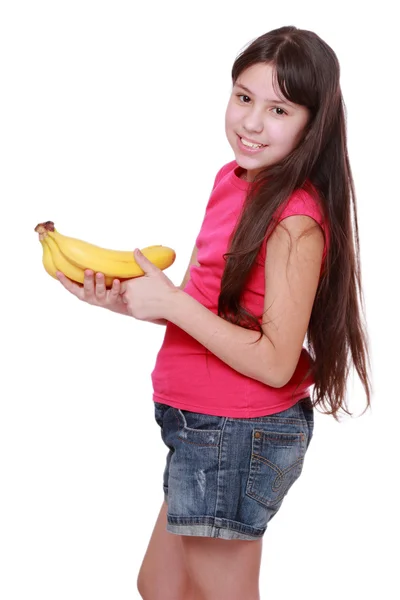 Chica sosteniendo plátanos amarillos —  Fotos de Stock