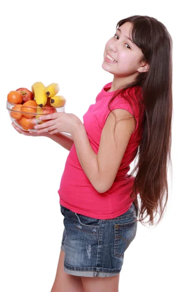 Girl holding fruit bowl — Stock Photo, Image