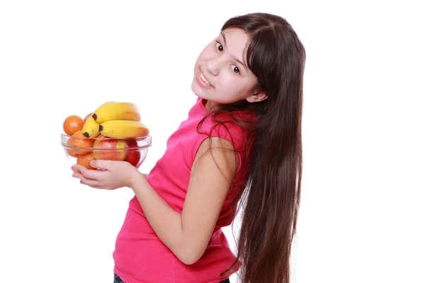 Girl holding fruit bowl — Stock Photo, Image