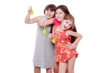 Cheerful little girls holding colorful eggs for Easter clipart
