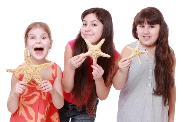 Girls holding starfishes — Stock Photo, Image