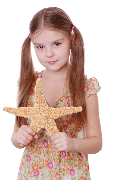 Flicka som håller en sjöstjärna — Stockfoto