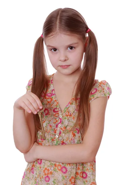 Girl holding golden vintage old key — Stock Photo, Image