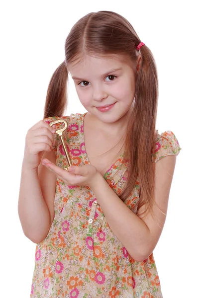 Girl holding golden vintage old key — Stock Photo, Image