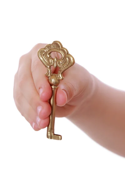 Girl holding golden vintage old key — Stock Photo, Image