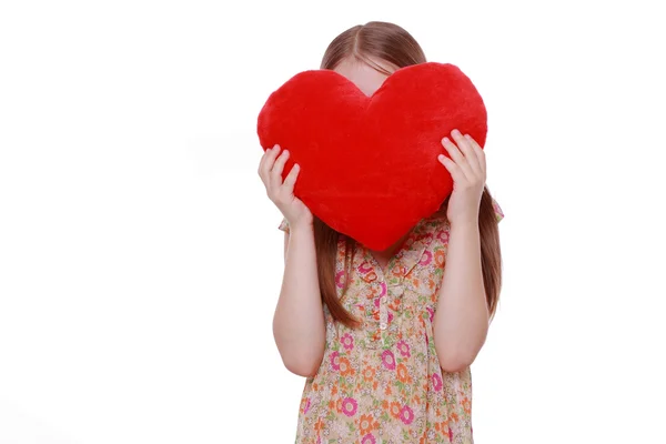Chica abrazando un gran corazón rojo — Foto de Stock