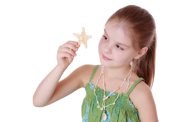 Little girl holds little star fish — Stock Photo, Image