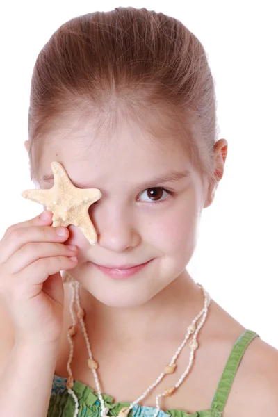 Little girl holds little star fish — Stock Photo, Image