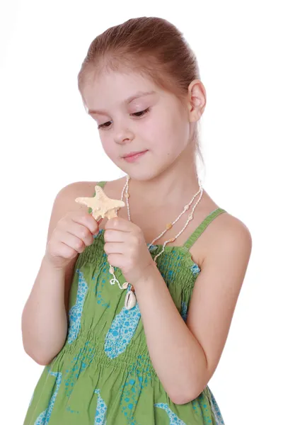 Little girl holds little star fish — Stock Photo, Image