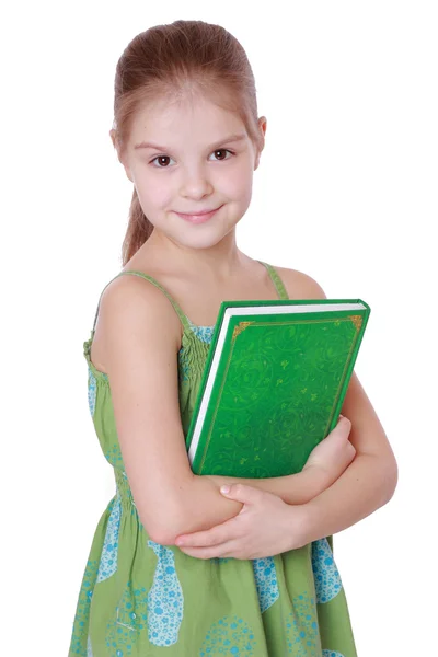 Menina segurando livro verde grande — Fotografia de Stock