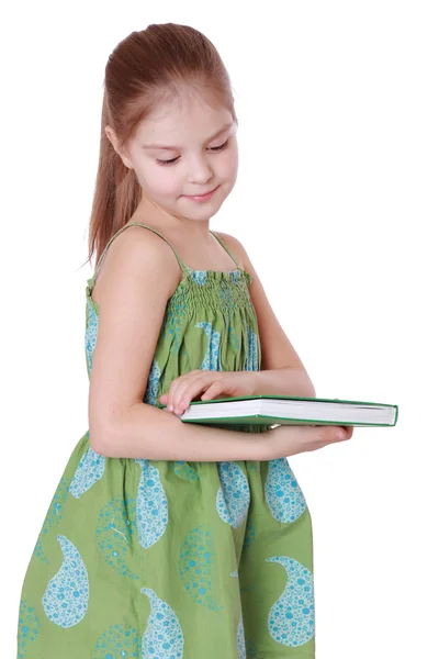 Menina segurando livro verde grande — Fotografia de Stock