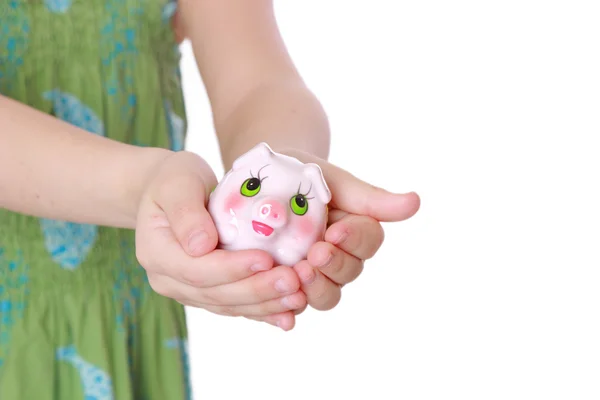 Girl saving money in a piggy-bank — Stock Photo, Image