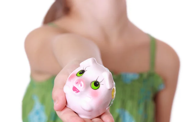 Girl saving money in a piggy-bank — Stock Photo, Image