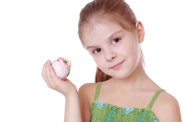 Meisje geld te besparen in een piggy-bank — Stockfoto