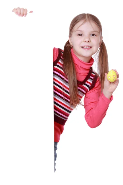 Girl holding Easter egg and white blank — Stock Photo, Image