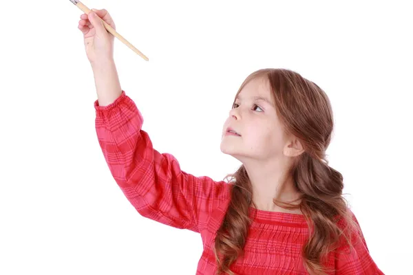 Girl holding a painting brush — Stock Photo, Image