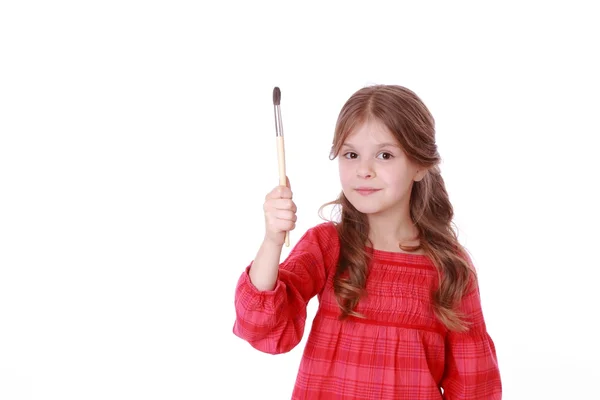 Girl holding a painting brush — Stock Photo, Image