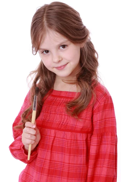 Girl holding a painting brush — Stock Photo, Image