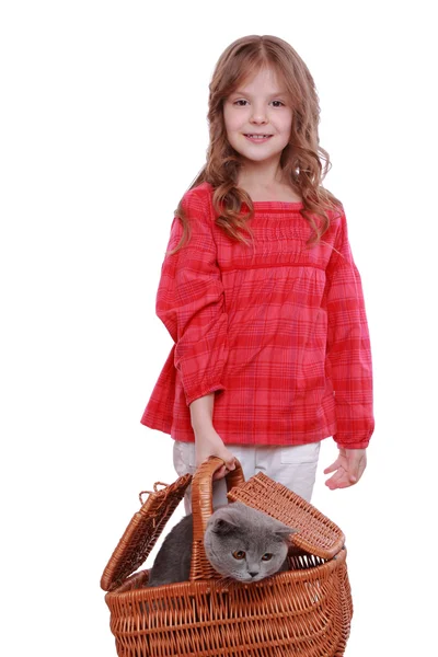 Girl holding cat in a basket — Stock Photo, Image