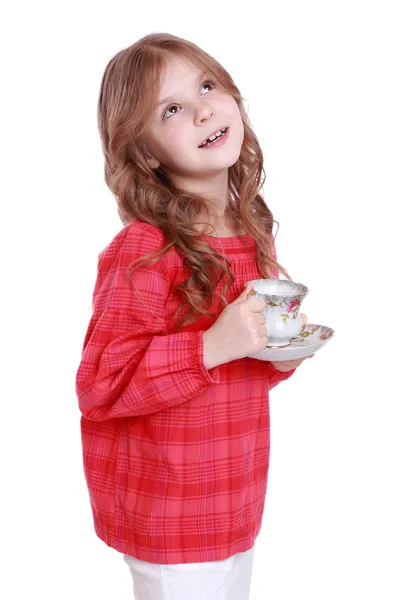 Little girl with a tea cup and sauce — Stock Photo, Image
