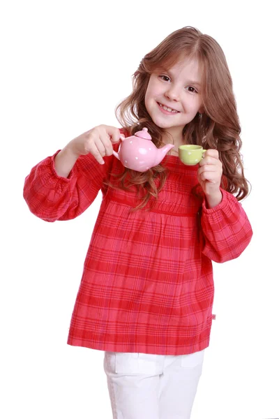 Girl playing with miniature tea — Stock Photo, Image