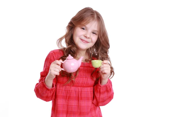 Girl playing with miniature tea — Stock Photo, Image