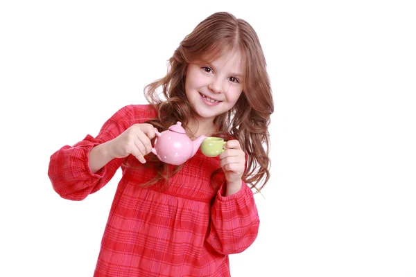 Little girl playing with miniature tea set — Stock Photo, Image