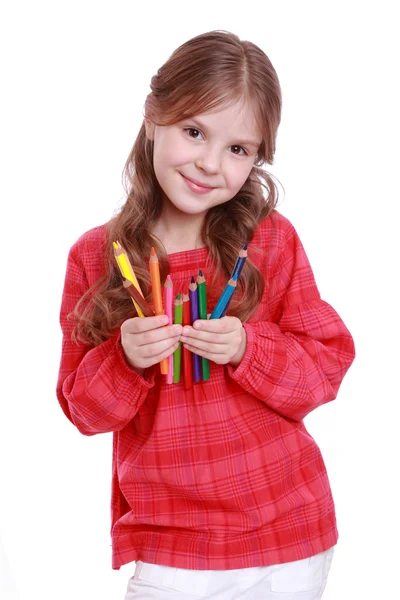 First grader holding colorful pencils — Stock Photo, Image