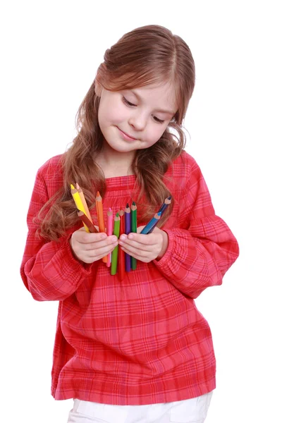 First grader holding colorful pencils — Stock Photo, Image