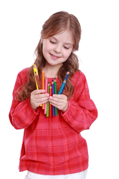 First grader holding colorful pencils — Stock Photo, Image