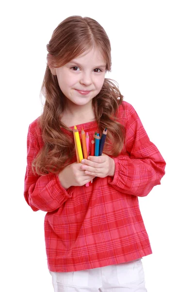 First grader holding colorful pencils — Stock Photo, Image