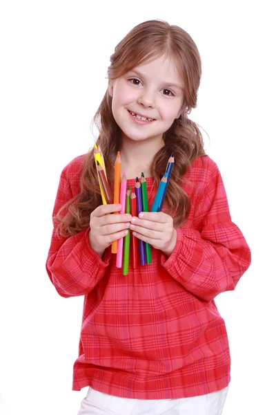 First grader holding colorful pencils — Stock Photo, Image