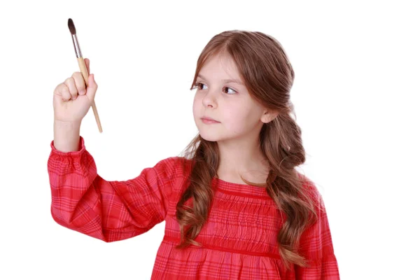 Girl with a brush in hand — Stock Photo, Image