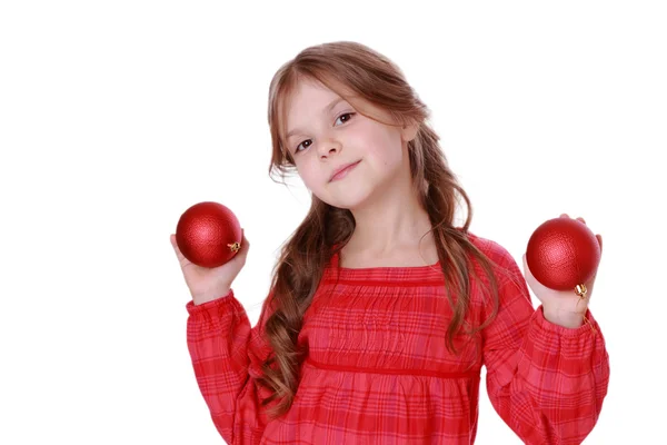 Menina segurando bolas decorativas vermelhas — Fotografia de Stock