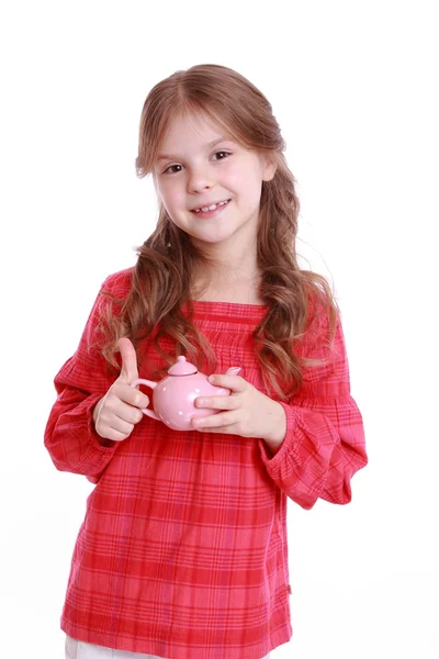 Girl playing with miniature tea set — Stock Photo, Image