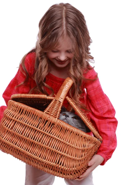 Girl holding cat in basket — Stock Photo, Image