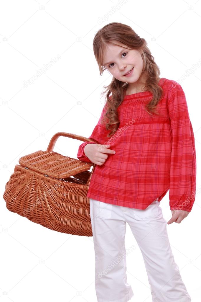 Little girl holding a picnic basket