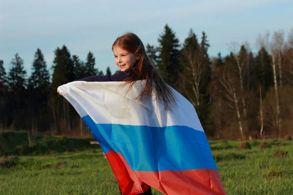 Girl holding a large Russian flag — Stock Photo, Image