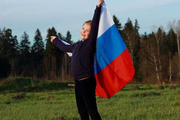 Girl holding a large Russian flag — Stock Photo, Image