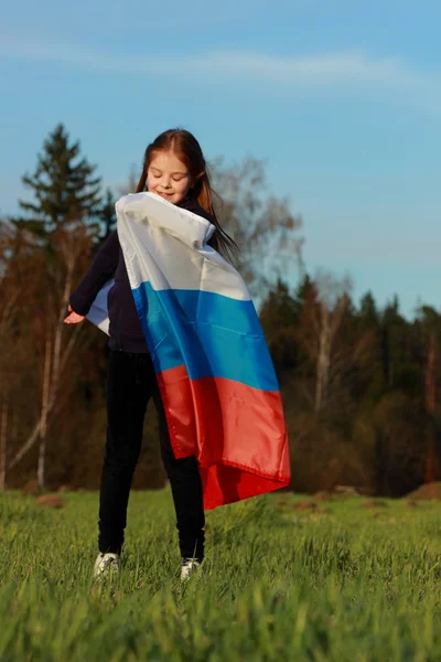 Girl holding a large Russian flag — Stock Photo, Image