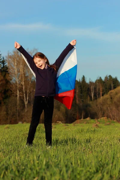 Girl holding a large Russian flag — Stock Photo, Image