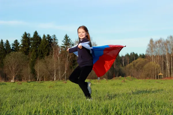Girl holding a large Russian flag — Stock Photo, Image