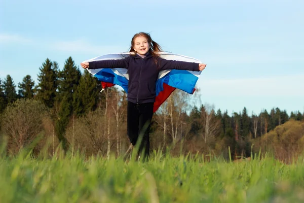 Fille tenant un grand drapeau russe — Photo