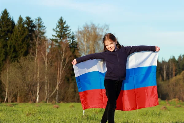 Girl holding a large Russian flag — Stock Photo, Image