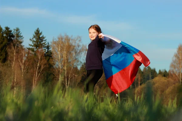 Girl holding a large Russian flag — Stock Photo, Image